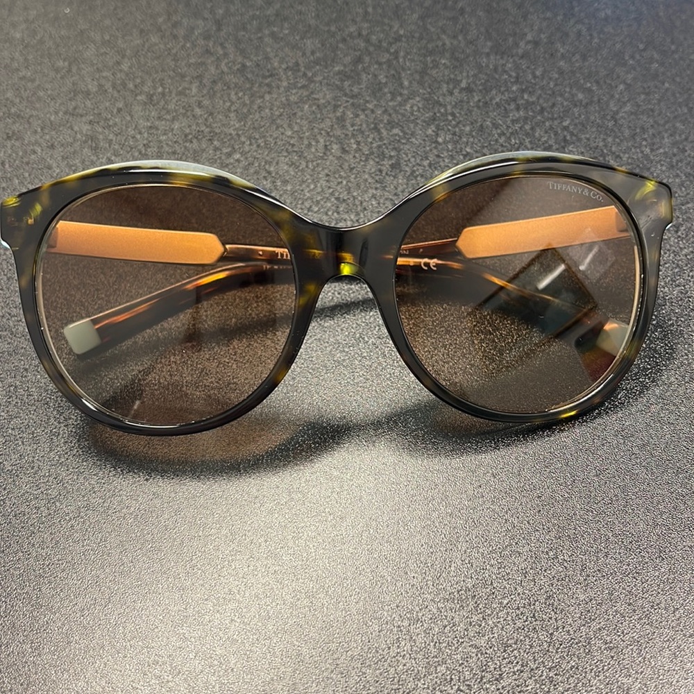 Tiffany sunglasses. One month old. No scratches. Includes case& cleaning cloth